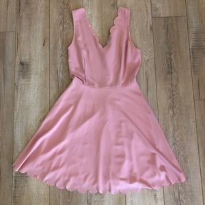 Pink dress with scallop neckline.